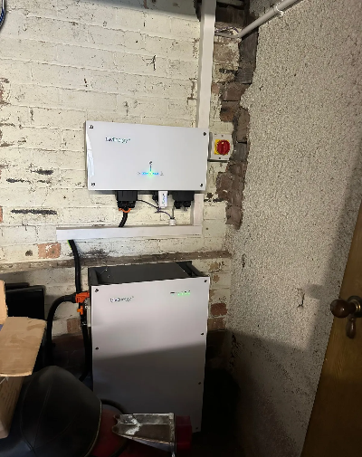 hand turning on a circuit breaker switch in an electrical panel with multiple labeled switches and safety indicators