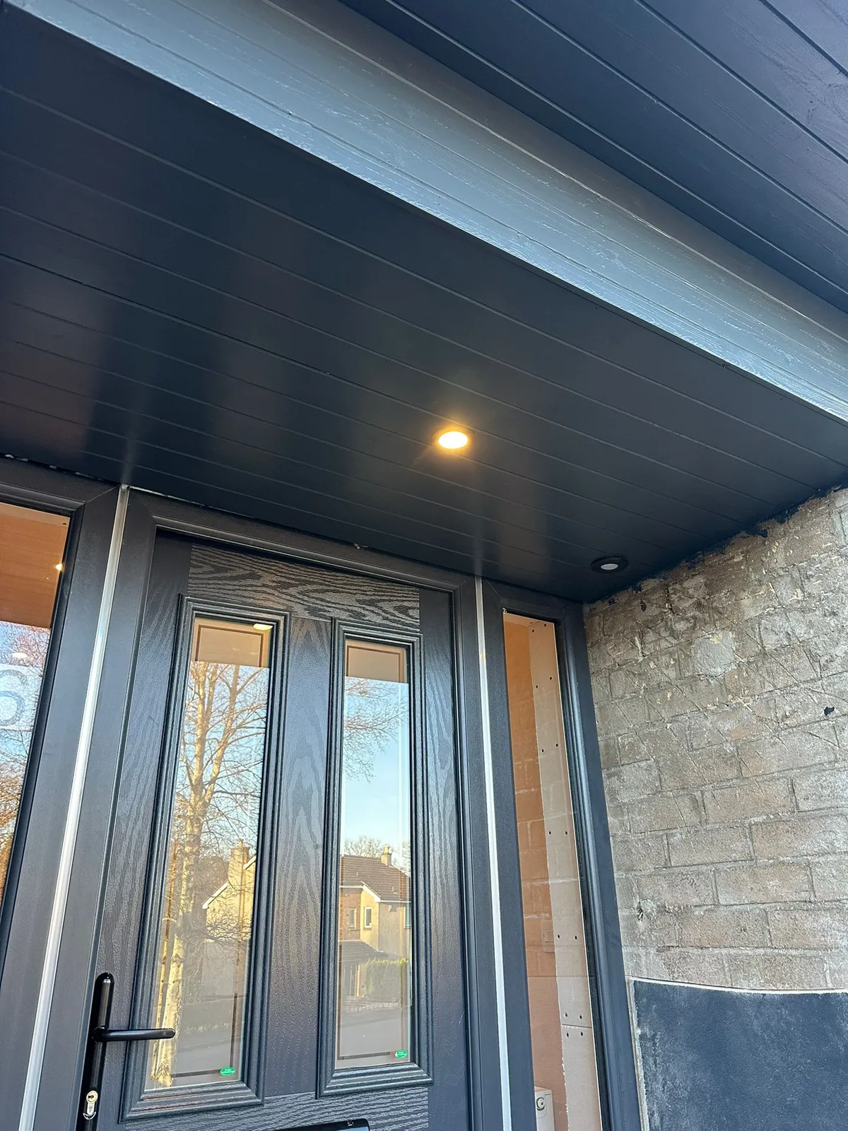 person installing electrical wall socket with screwdriver, connecting wires to power outlet